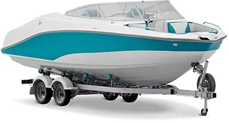 A white boat with a teal swoosh down the side sits on a boat trailer.